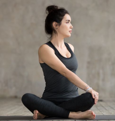 young woman in seated twist pose