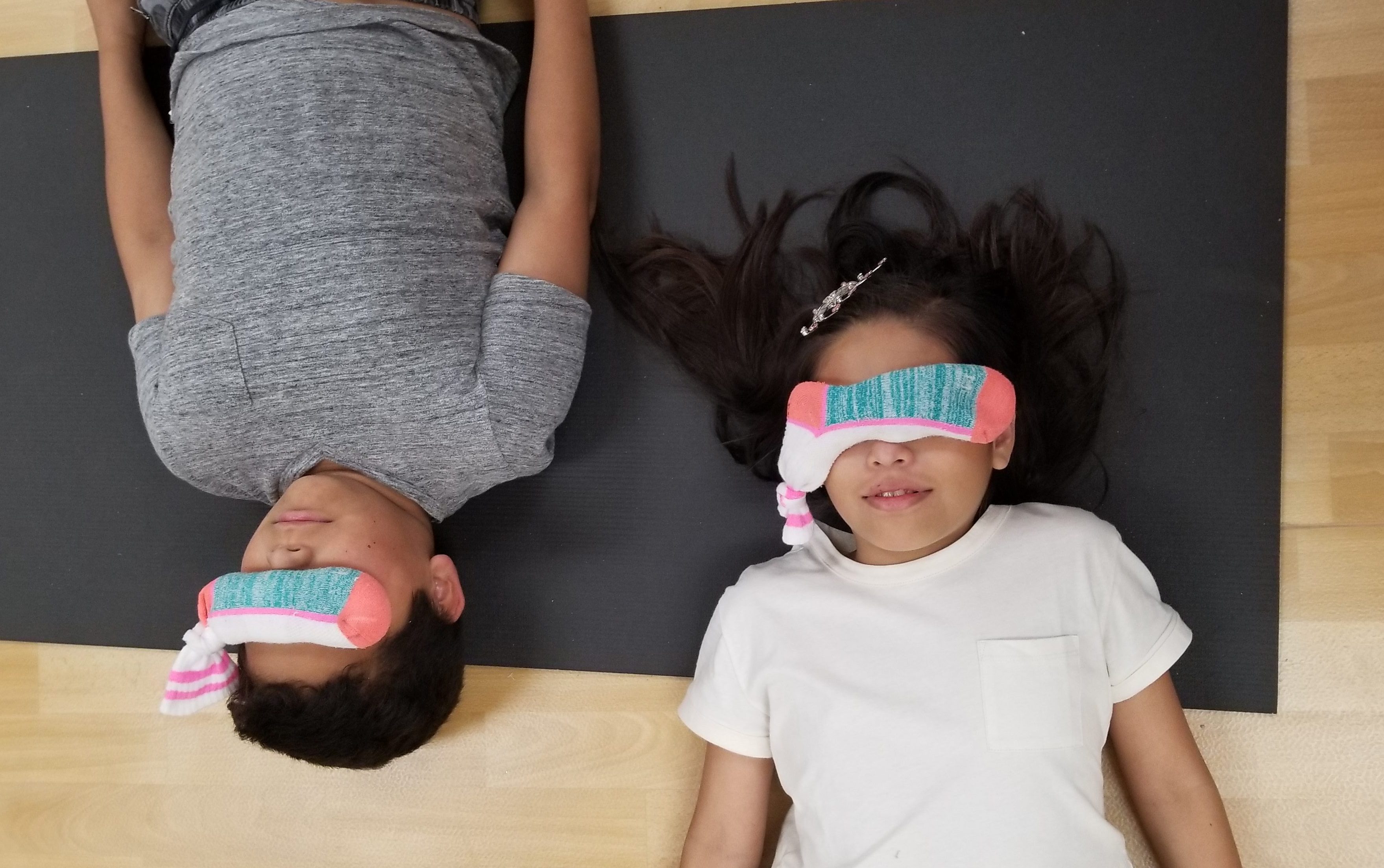 a girl and boy relaxing with no-sew DIY eye pillows on face